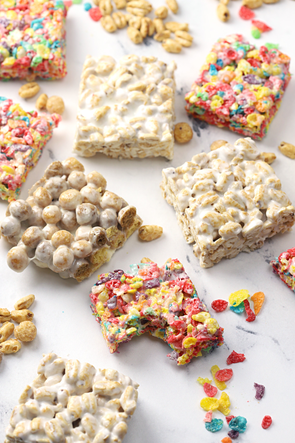 Cereal marshmallow treats on a marble counter top.