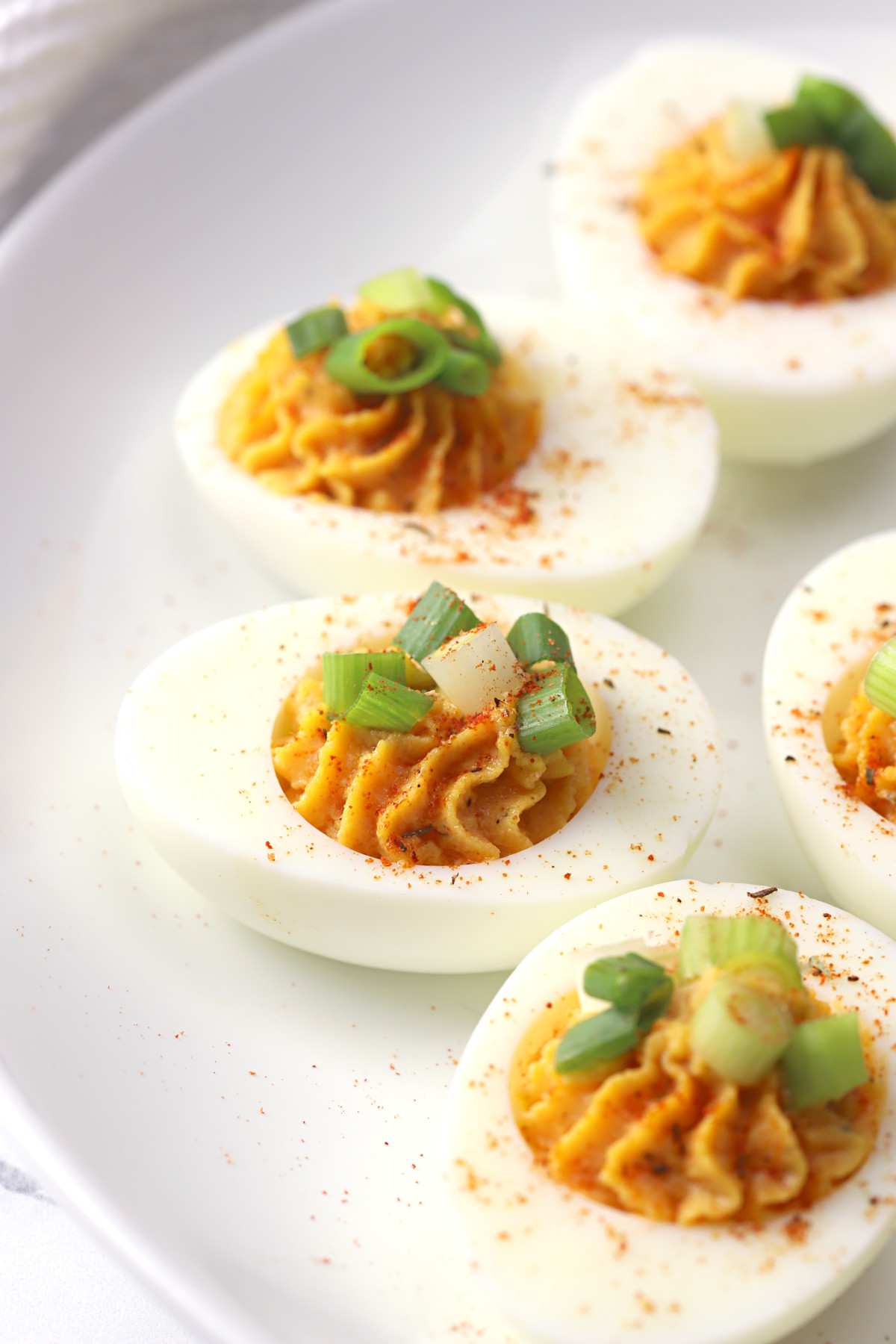 Deviled eggs topped with green onions.