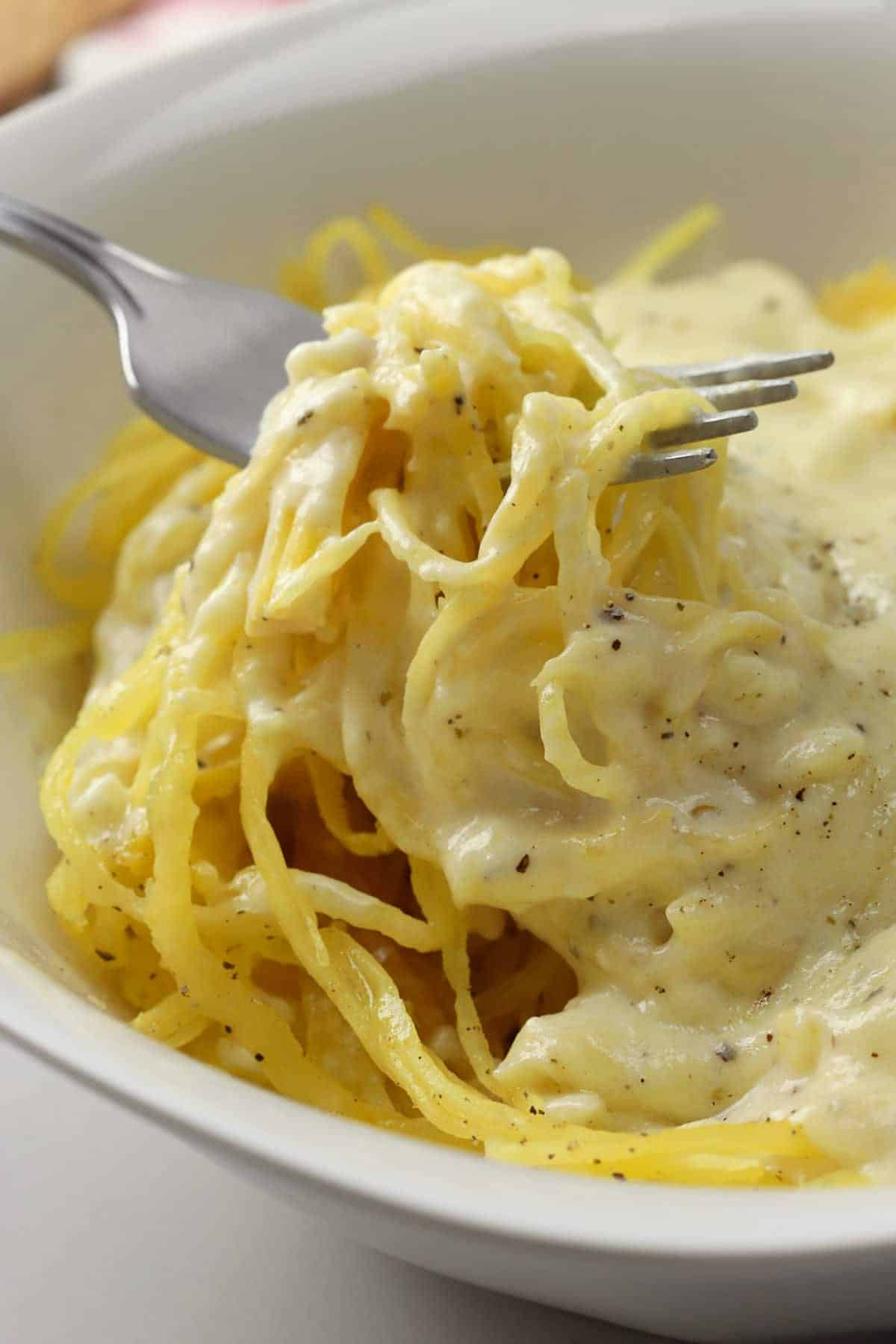 A fork full of spaghetti squash alfredo.