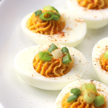 Deviled eggs topped with green onions.