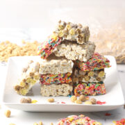 A white plate stacked with cereal marshmallow treats.