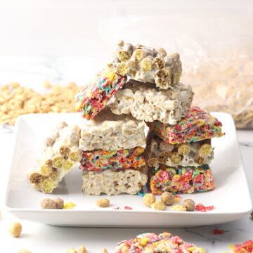 A white plate stacked with cereal marshmallow treats.