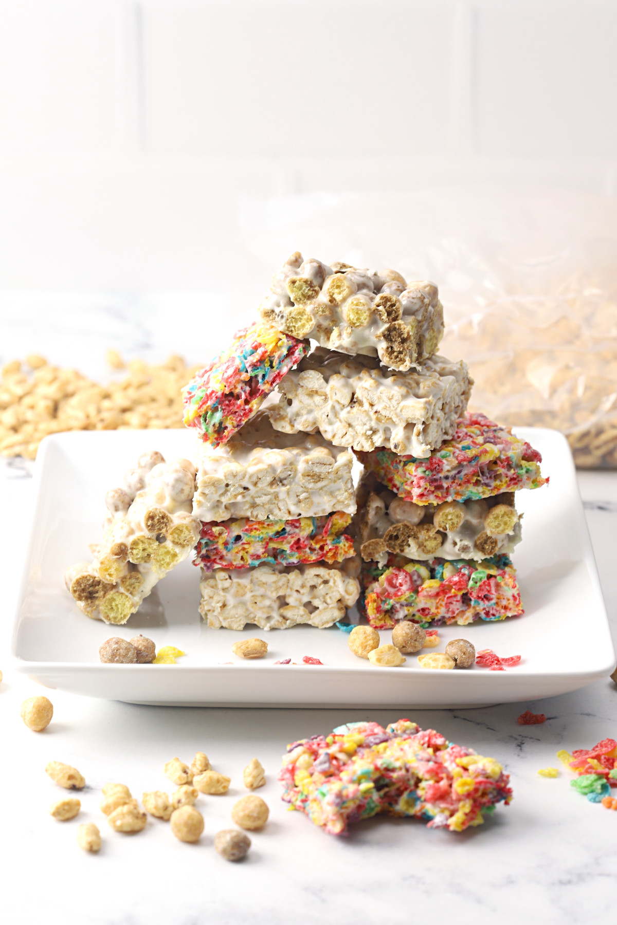 A white plate stacked with cereal marshmallow treats.