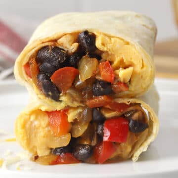 Black bean breakfast burrito sliced in half and stacked to show filling.