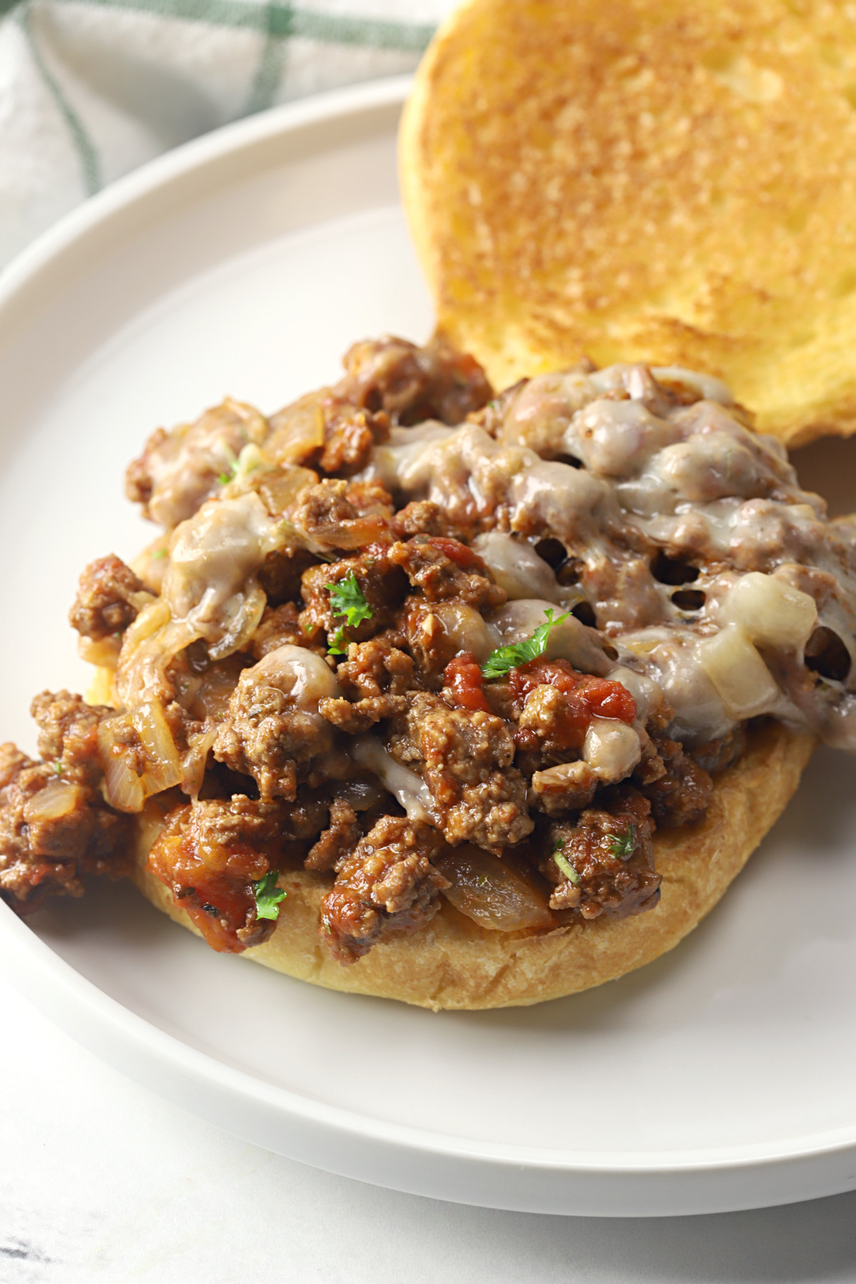 Sloppy joe topped with melted cheese.