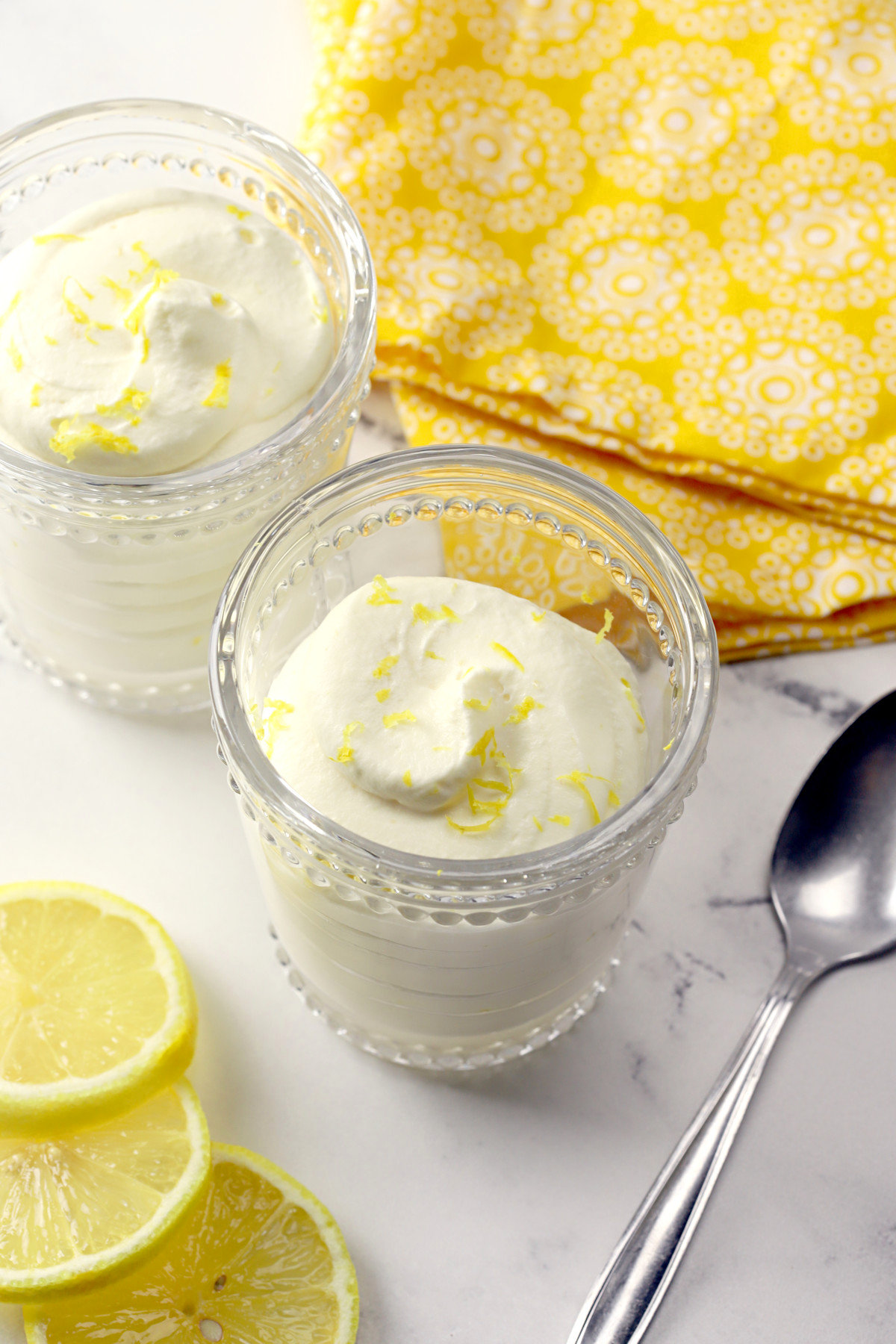 Two glass dishes filled with lemon mousse.