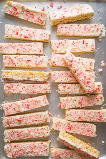 Rice krispes treats cut into sticks and topped with candy canes.