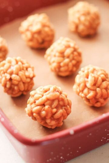 Peanut butter rice crispy balls on a baking sheet.