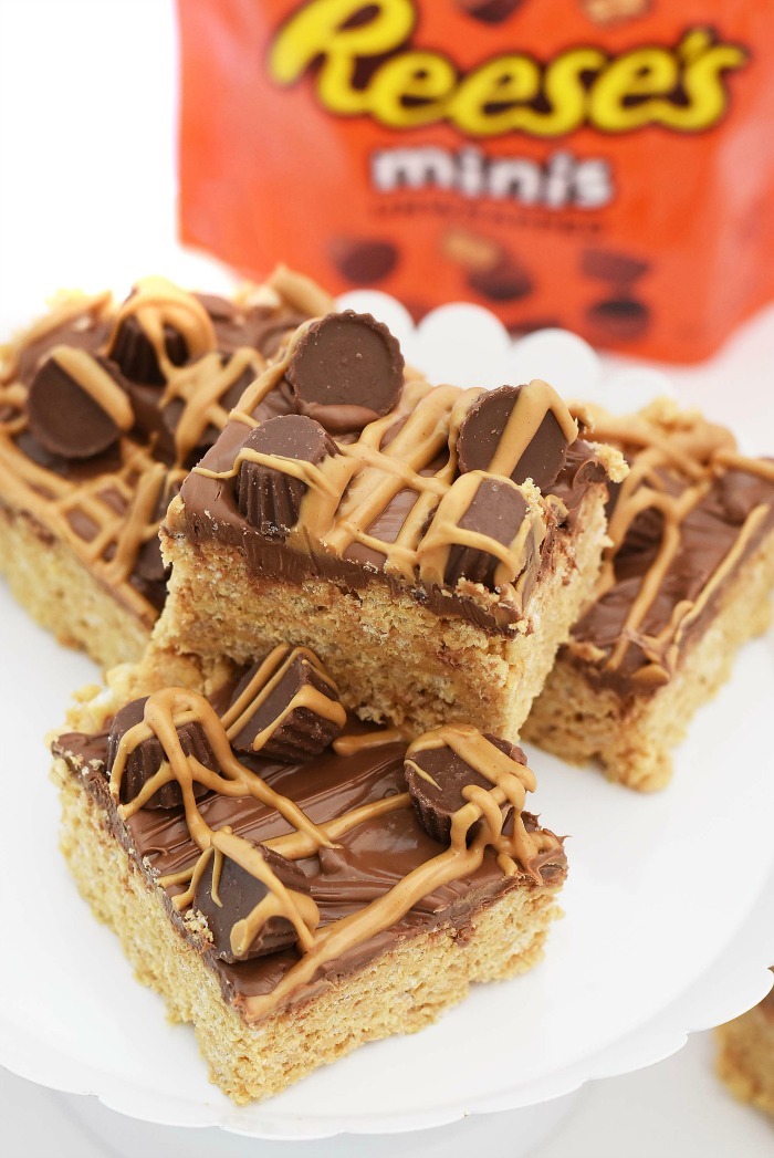 Rice krispies treats topped with reese's minis, chocolate, and peanut butter.