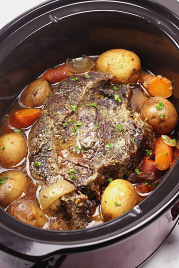 Beef roast in a large slow cooker.