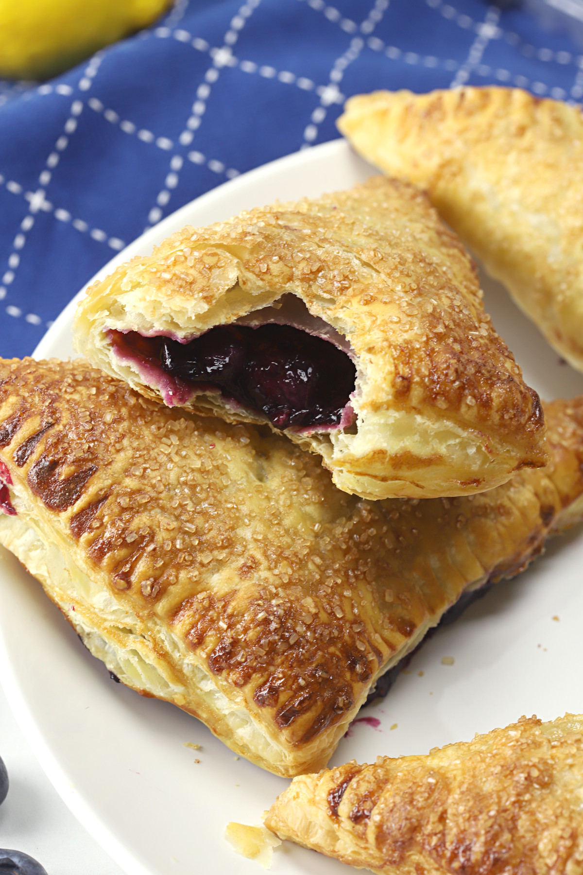 A bite taken from a blueberry turnover to show the fruit filling.