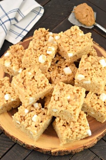 Peanut butter rice krispies treats stacked on a plate.