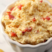 Scalloped bowl filled with pimento cheese.