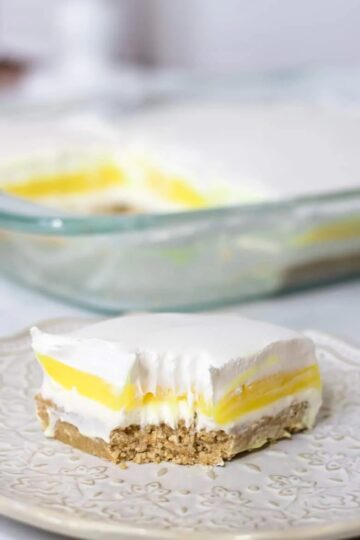 Slice of lemon lush dessert on a white plate.