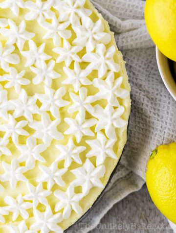 Lemon cheesecake topped with piped whipped cream flowers.
