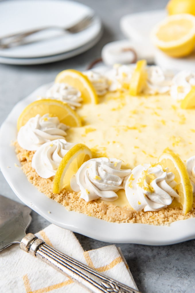 Pie topped with lemon slices and whipped cream.