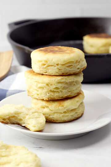 Biscuits stacked on a white plate.