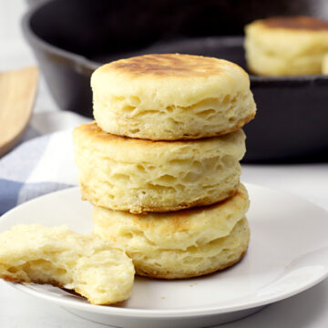 Stack of biscuits on a white plate.