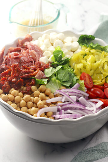 Ingredients on top of a bed of lettuce in a bowl.