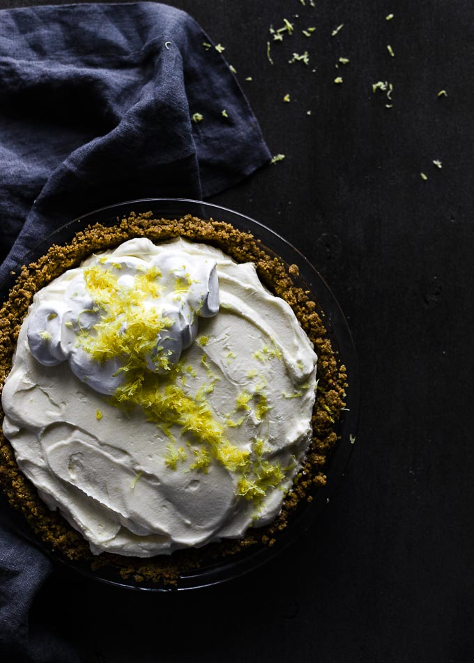 Pie topped with lemon zest and whipped cream.