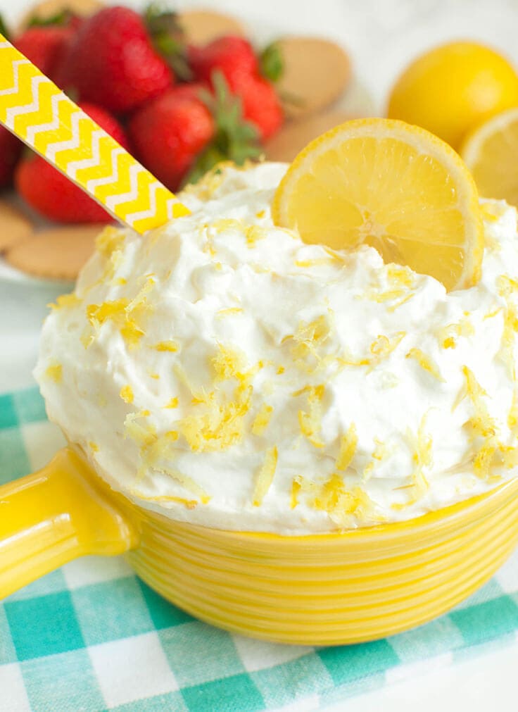 Yellow dish filled with lemon cream cheese fruit dip.