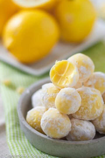 lemon truffles stacked in a bowl.