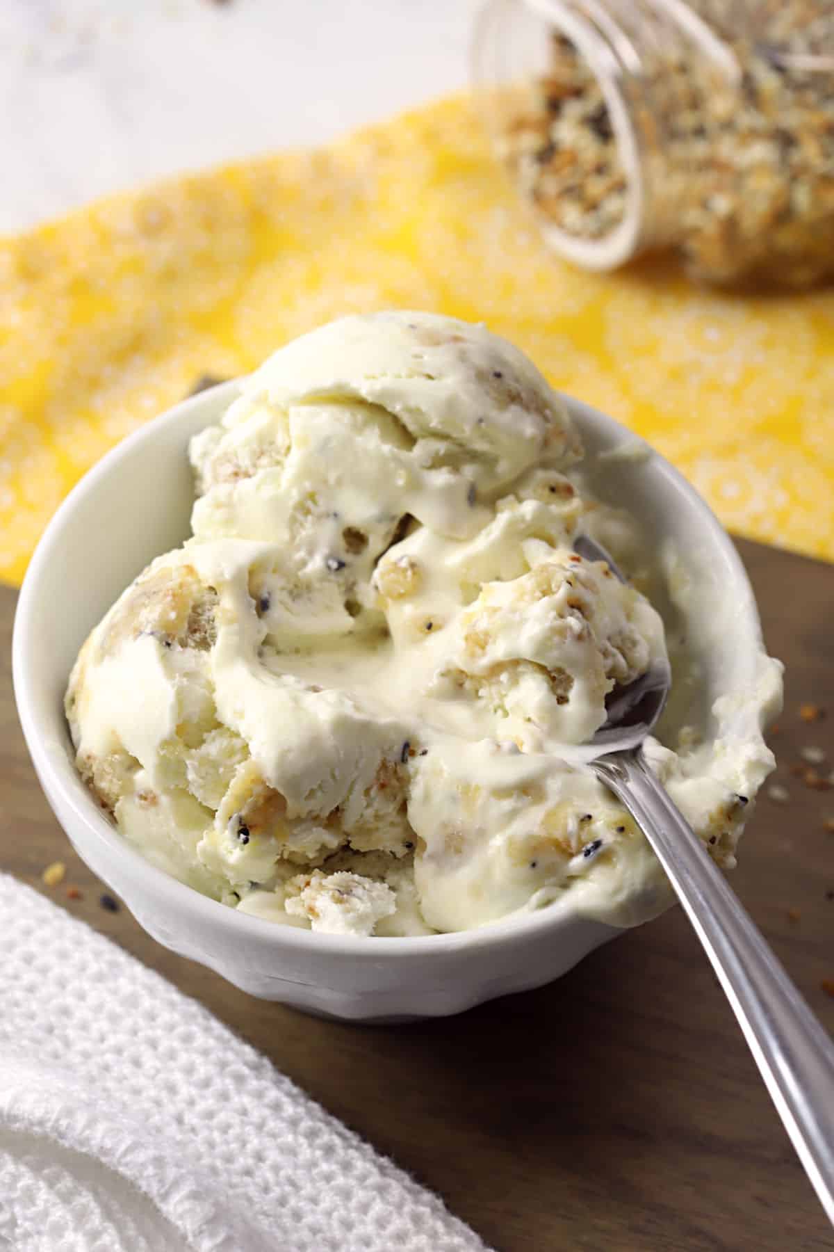 Melting ice cream in a white bowl with a spoon.