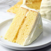 Slice of lemon layer cake on a serving plate.