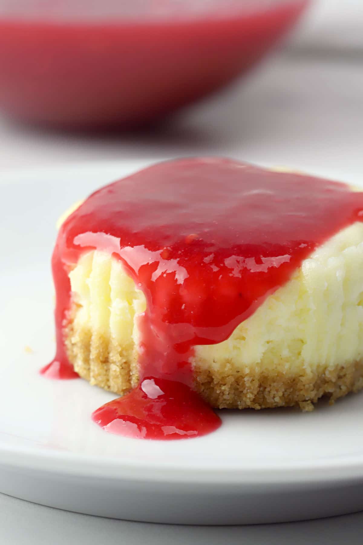 Cheesecake with raspberry sauce on top.