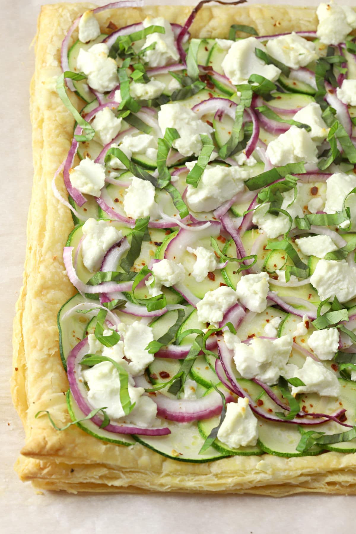 Puff pastry topped with zucchini, onions, and goat cheese.
