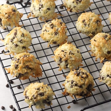 Chocolate chip coconut macaroons on a wire cooling rack.