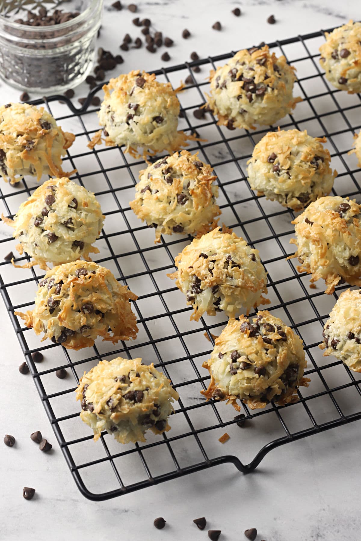 Chocolate chip coconut macaroons on a wire cooling rack.
