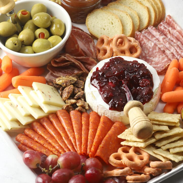 Meats and cheeses assembled onto a tray.