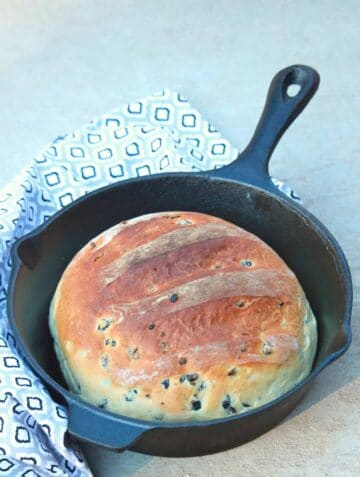 Moroccan olive bread in a cast iron skillet.