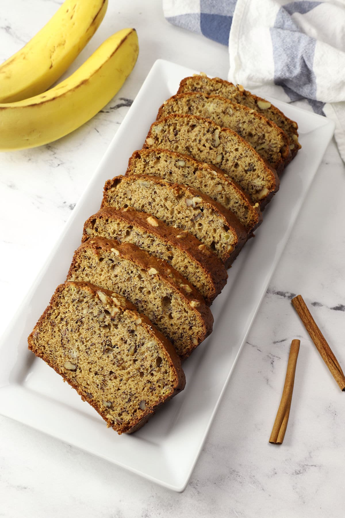 Slices of banana bread on a white serving plate.