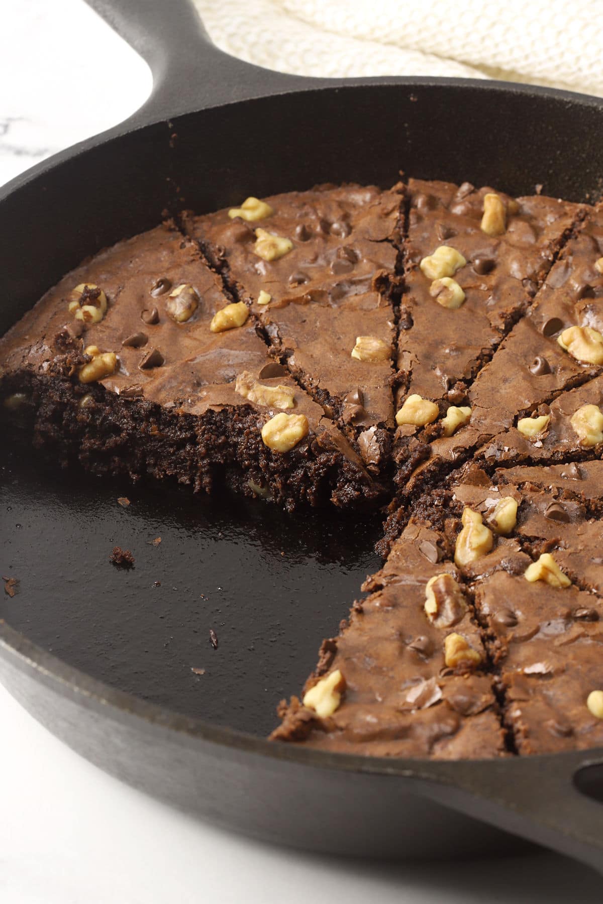 Cast iron skillet filled with sliced brownie wedges.