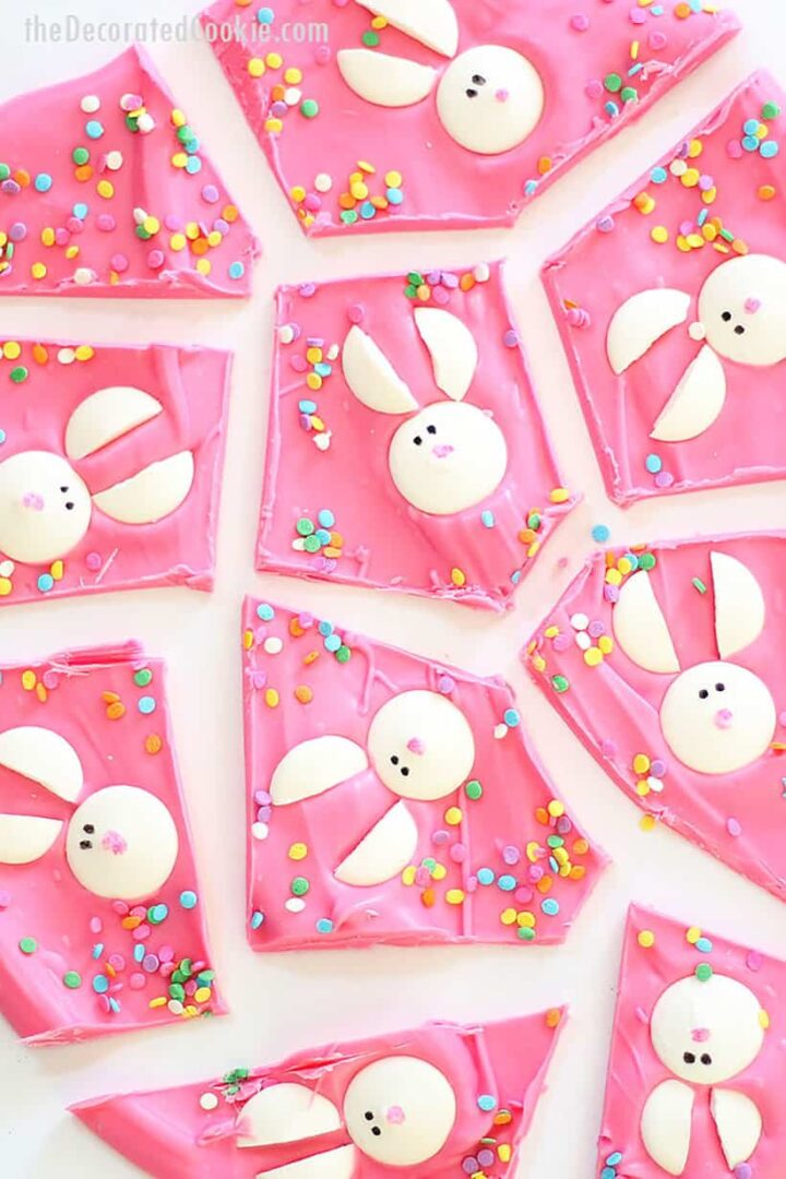 Pink chocolate bark decorated with white chocolate bunnies and sprinkles.