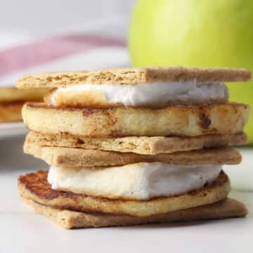 Two grilled apple s'mores stacked on top of each other.