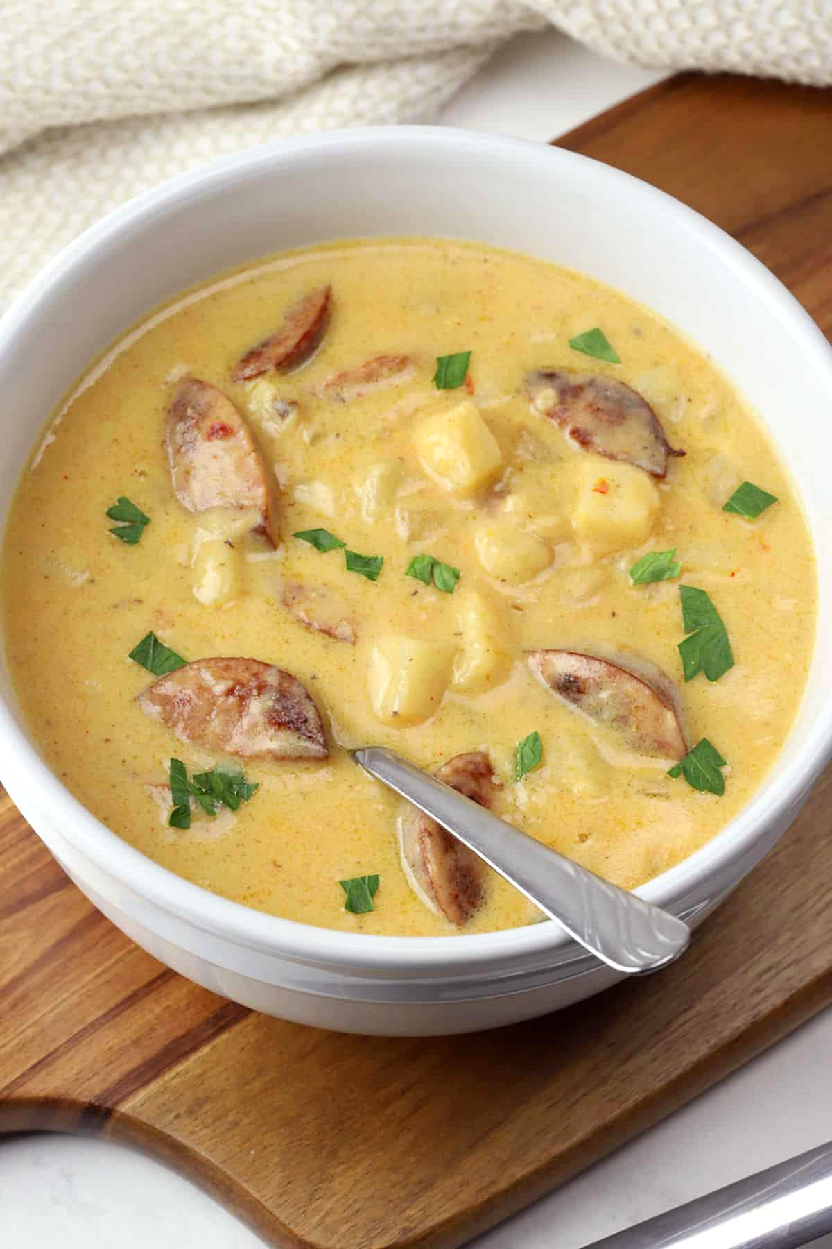 A white bowl filled with creamy potato soup.