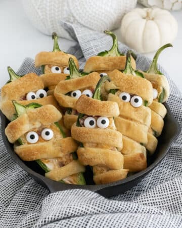 Jalapeno poppers wrapped in dough to look like mummies.