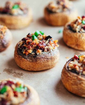 Mushrooms stuffed with bacon on a counter top.