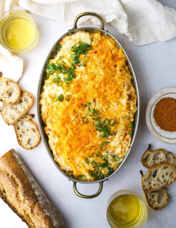 An oval serving dish filled with pimento cheese crab dip.