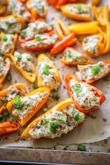 Halved peppers stuffed with cream cheese and onions.