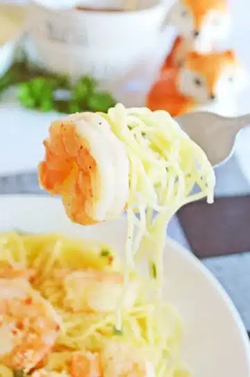 Pasta and shrimp on a fork.
