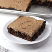 Chocolate 13x18 sheet cake slice served on a plate.