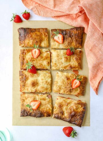 Squares of tart garnished with strawberry slices.