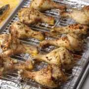 Oven roasted chicken drumsticks on a sheet pan.