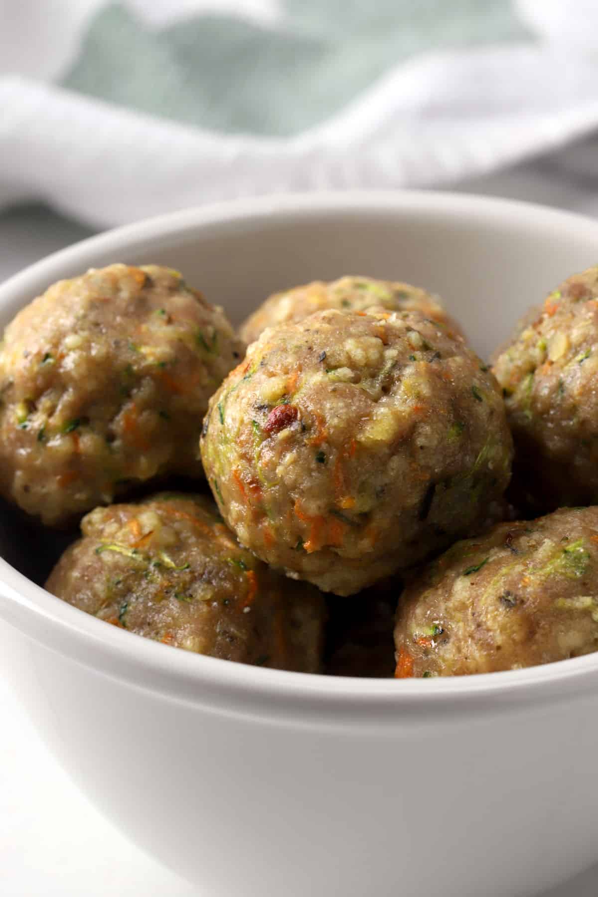 A bowl filled with turkey veggie meatballs.