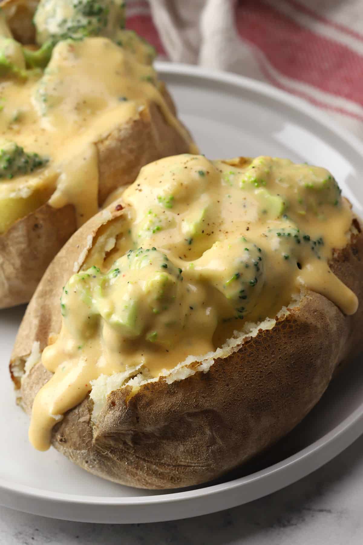 Close up of broccoli cheese sauce on a baked potato.