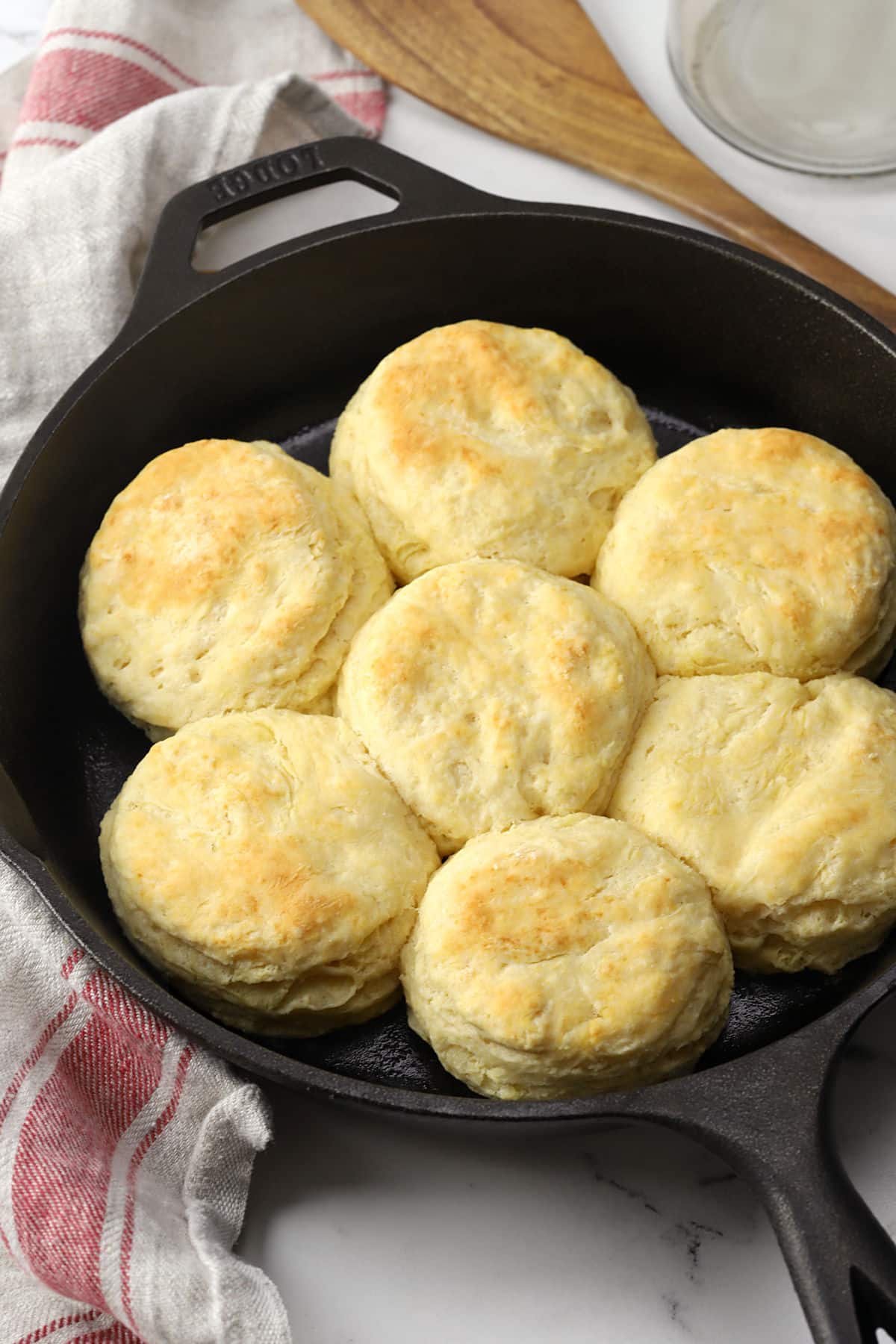Cast iron pan filled with baked buttermilk biscuits.
